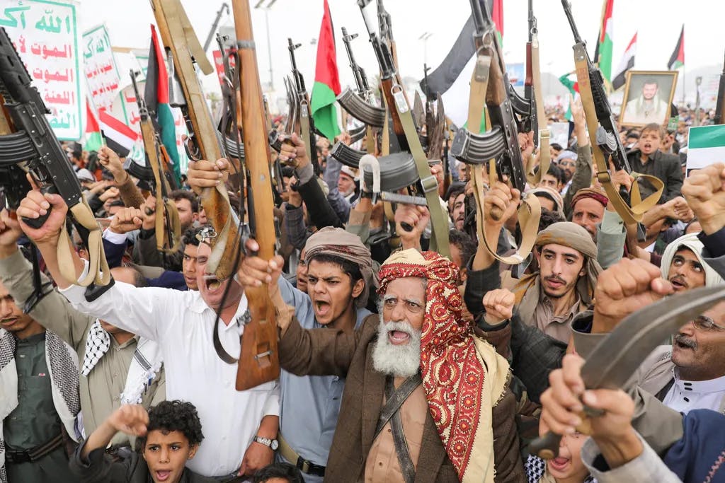 Men in kaffiyahs with knives and Palestinian flags