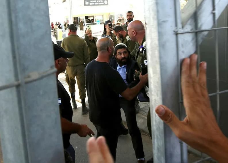 Bearded man seen through security gates