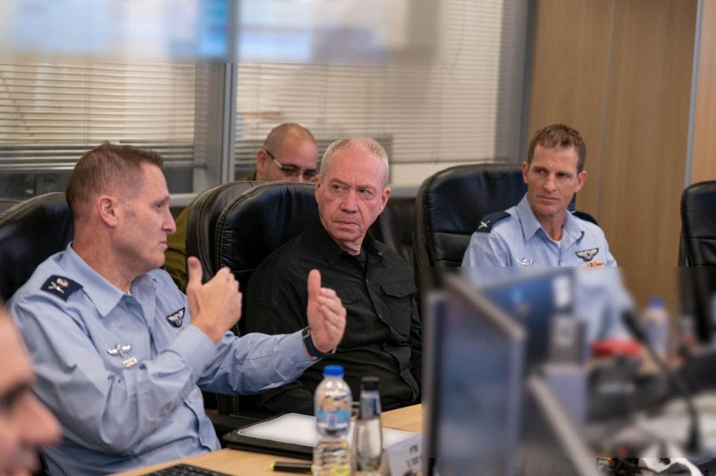 Three men, two in airforce uniform, one gesturing