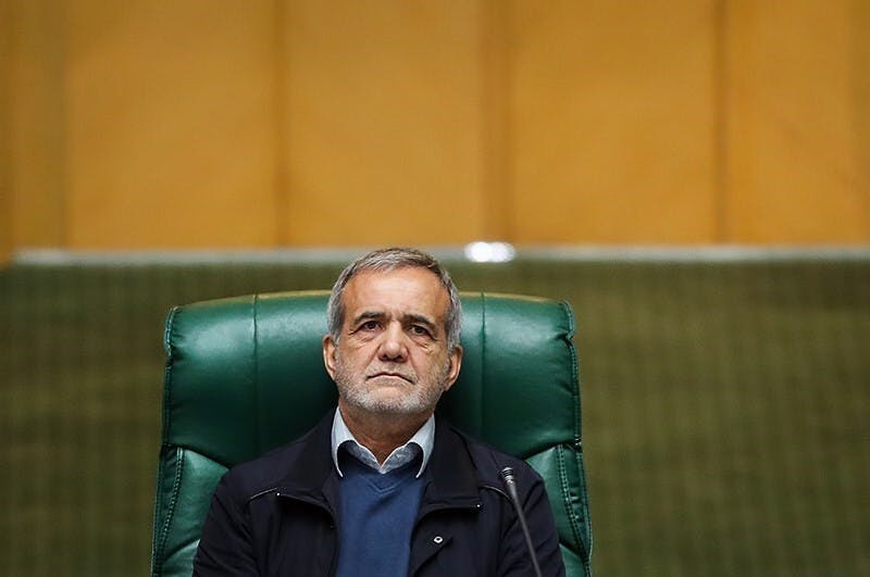 Man looking pensive in green chair.