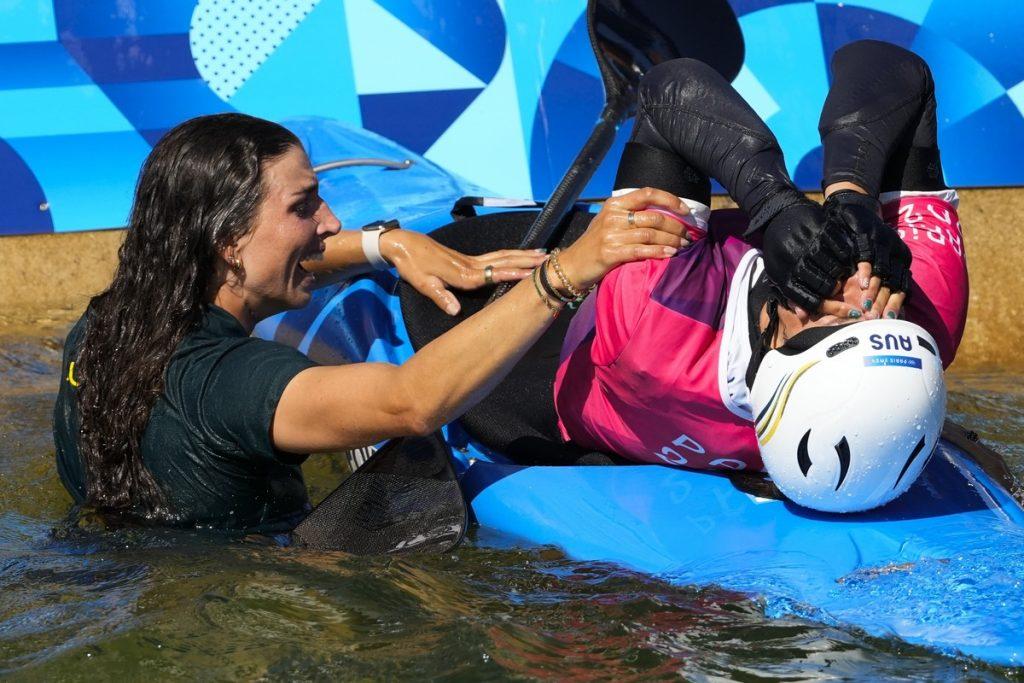 Jess Fox jumps into celebrate with sister Noémie (AP/Kirsty Wigglesworth)