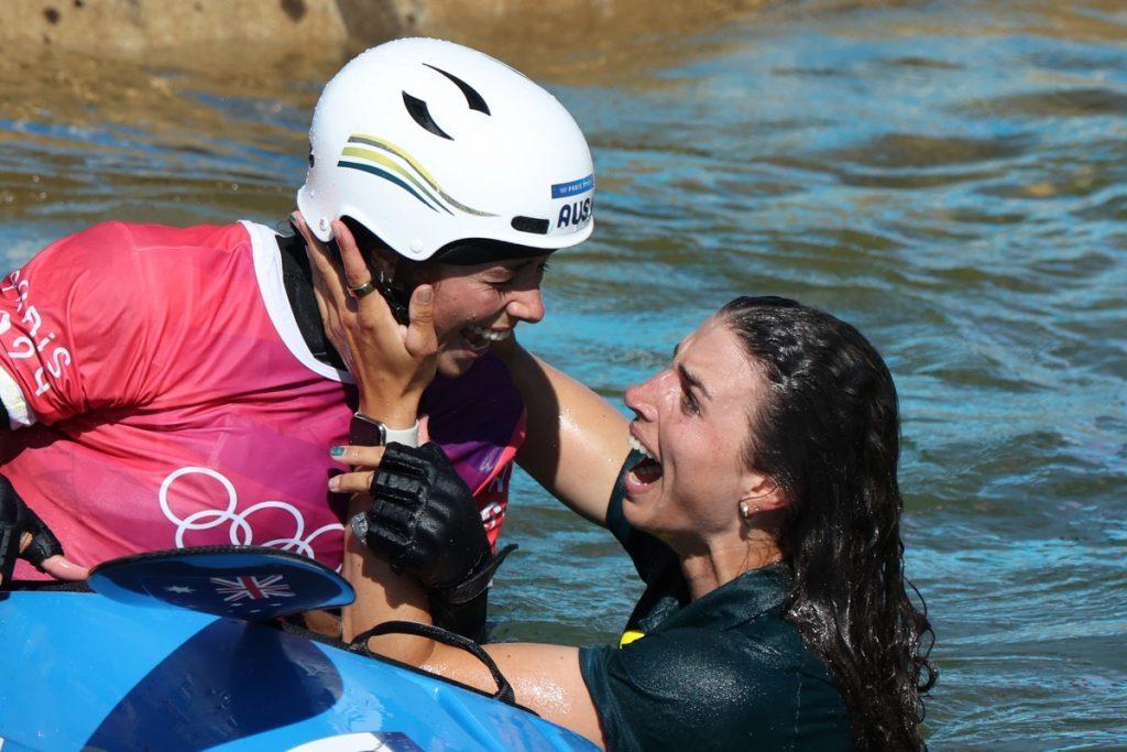 Noémie Fox is hugged by older sister Jess after winning the Kayak Cross (EPA/Maxim Shipenkov)