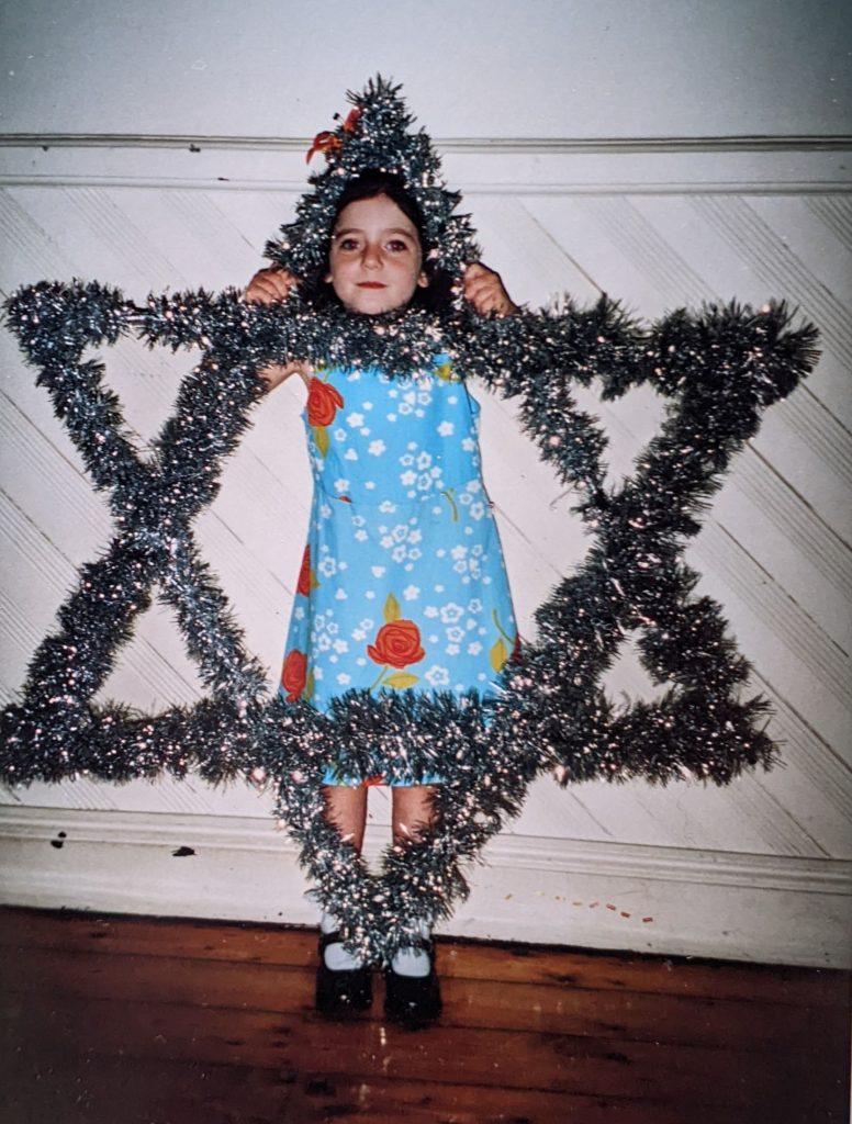 Holt as a child dressed as a Star of David