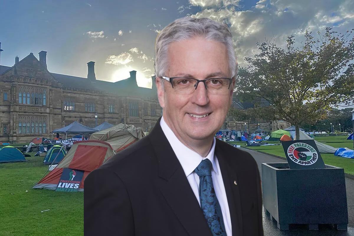 Man in front of university buildings with tents