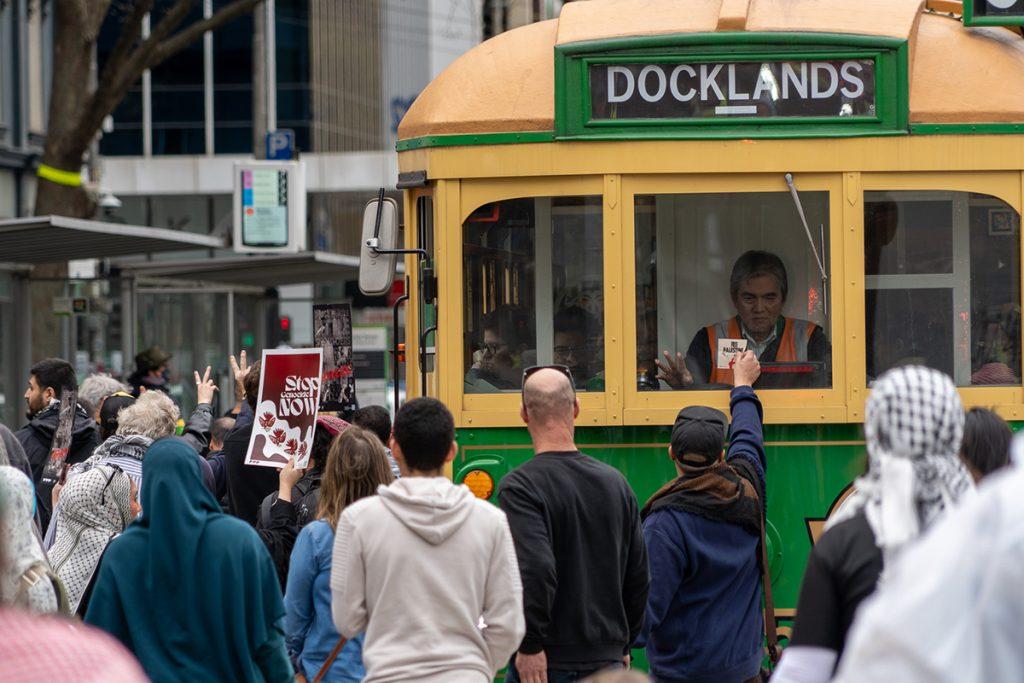 Pro-Palestine protesters block a tram in Melbourne on Sunday (Image: Ben Bresley).