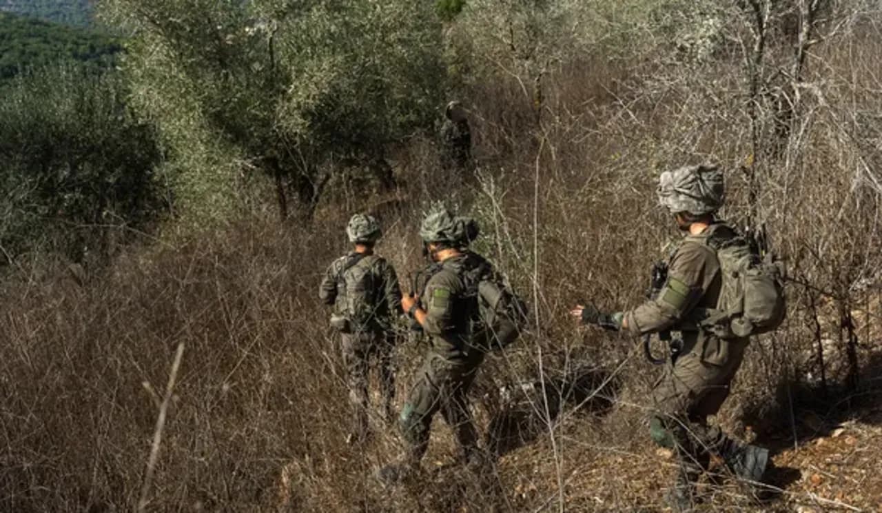 3 soldiers in combat uniforms in long dried grass