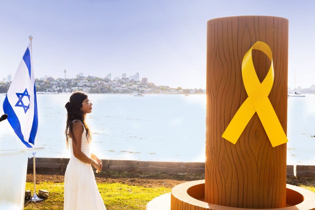 Survivor Michal Ohana with the Sydney sand sculpture (ZFA)