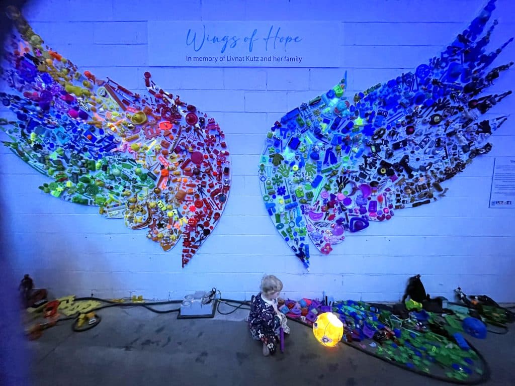 A child plays with toys at the Wings of Hope installation in memory of the Kutz family at Illuminate October (Deborah Stone)