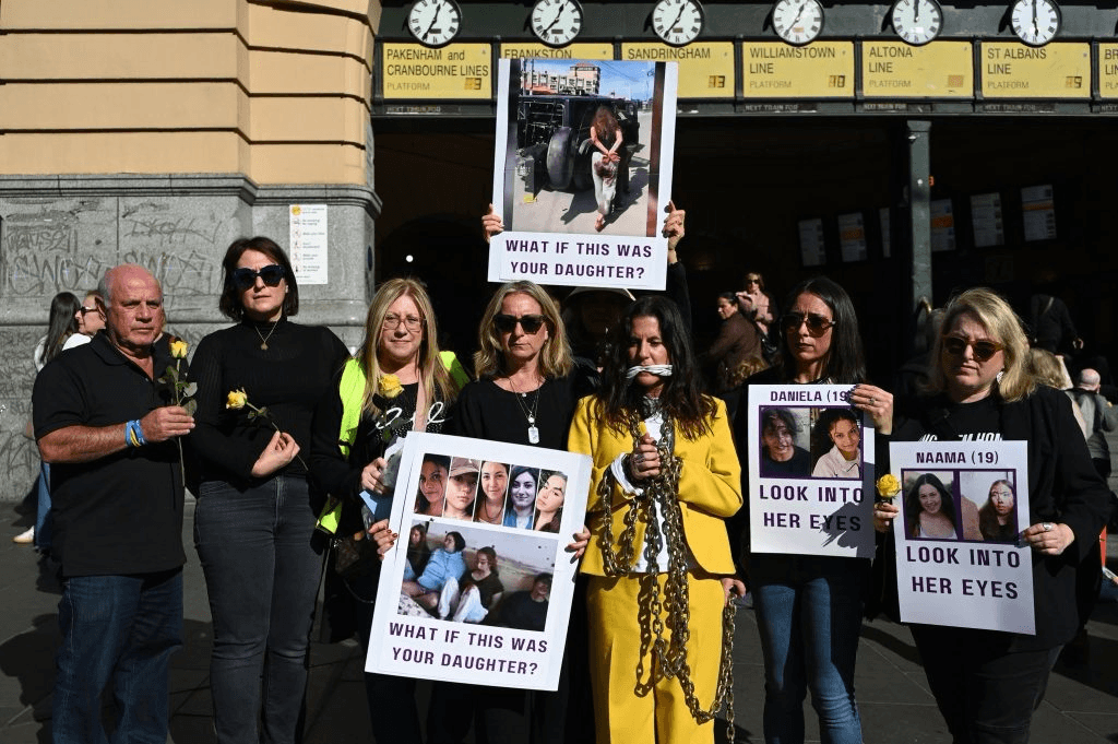 Jewish women hold a vigil in support of women hostages at Flinders Street station in Melbourne (supplied)