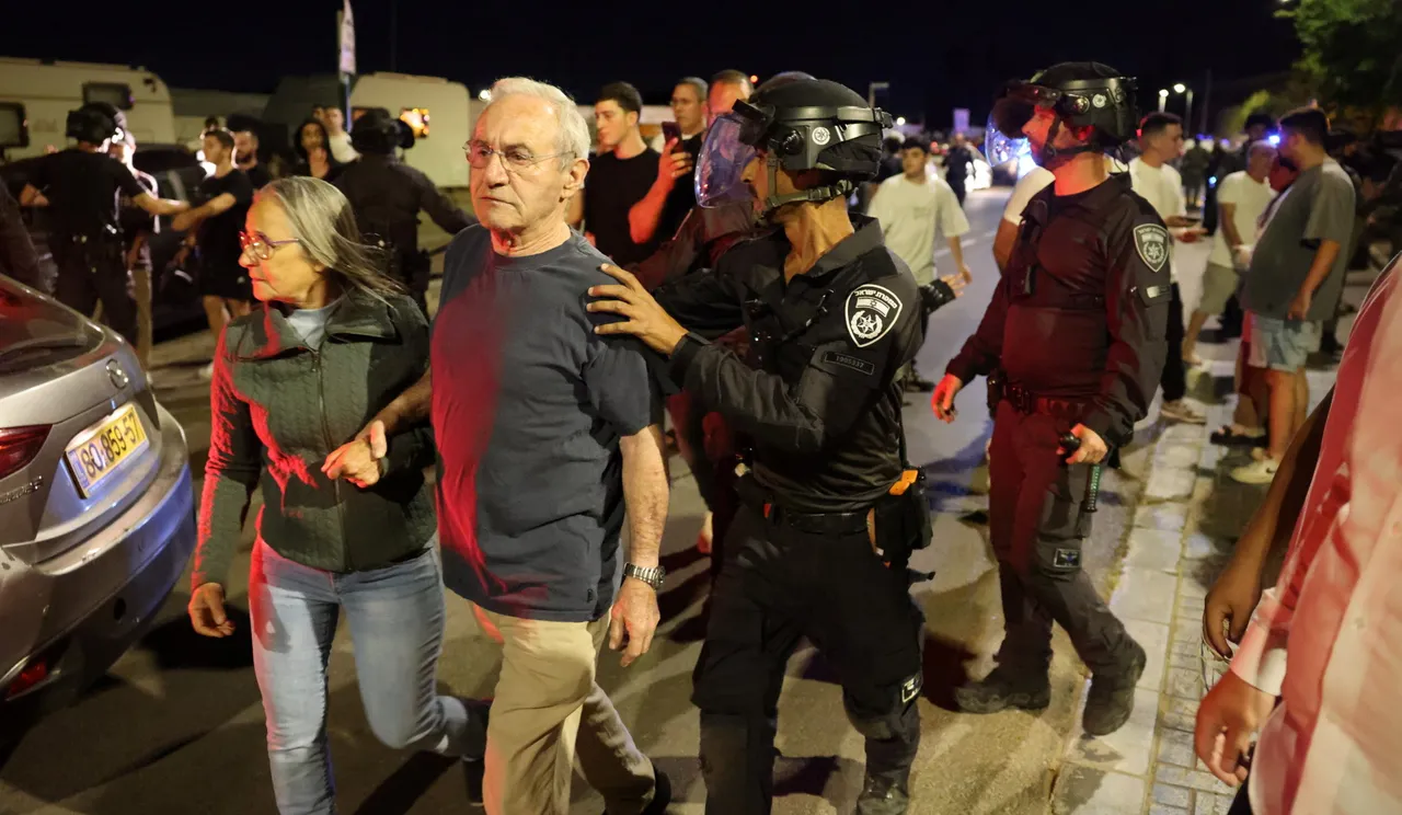 Man and woman being escorted by uniformed officer in a crowd