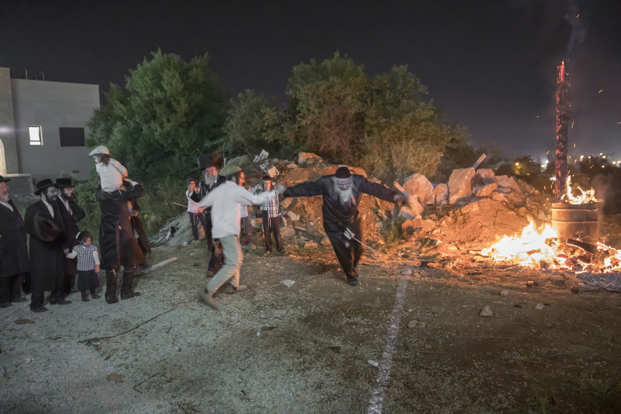 Men dancing around a bonfire