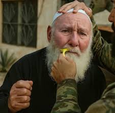 A Druze man's facial hair being shaven off as an act of humiliation (Image: X).